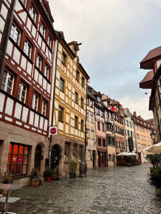 Colourful half-timbered houses line the empty cobblestoned street of Weißgerbergasse in Nuremberg