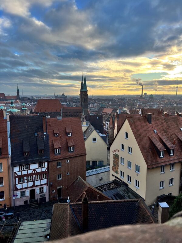 Quaint townhouses and church spires form the view from the Kaiserburg terrace back over the city of Nuremberg at sunset