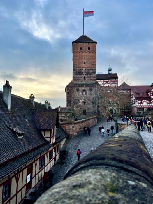 A tower illuminated at sunset at the Kaiserberg Fortress above Nuremberg, is Nuremberg worth visiting?