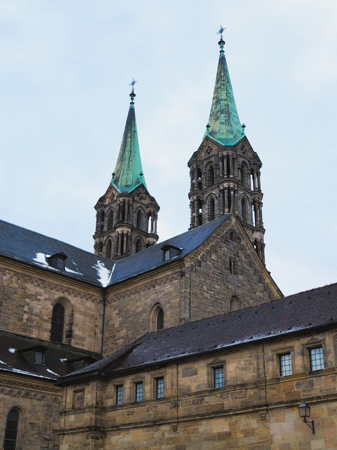 Two copper plated cathedral spires rise high above the sandstone walls of the Bamberg Cathedral and the Old Courtyard