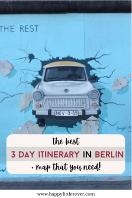 A light blue mural is painted onto a concrete wall with an old-fashioned Trabant car pictured breaking through. The text reads the best Berlin 3 day itinerary & map that you need!